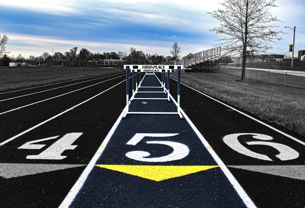 A running track with white numbers and arrows