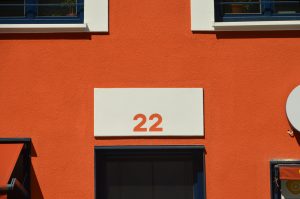 A red building with a white sign with the number 22 on it