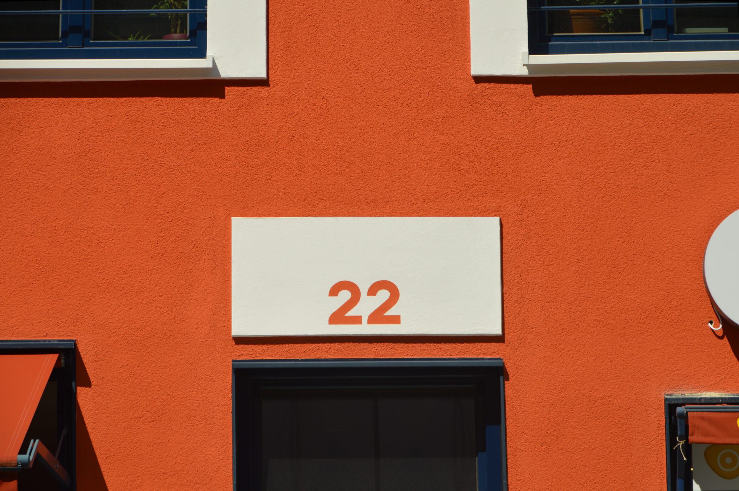 A red building with a white sign with the number 22 on it