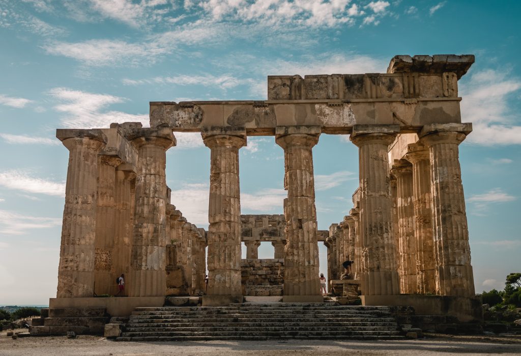 An old building with pillars under the sky