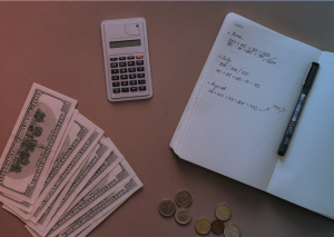 A table with money, notebook, and calculator