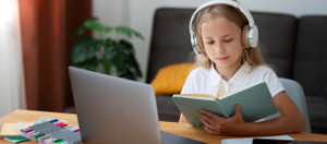 Student in headphones in front of the laptop