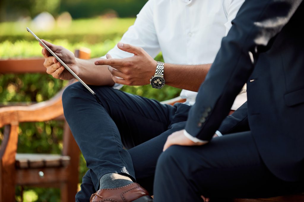 a man demonstrates its phone to another man