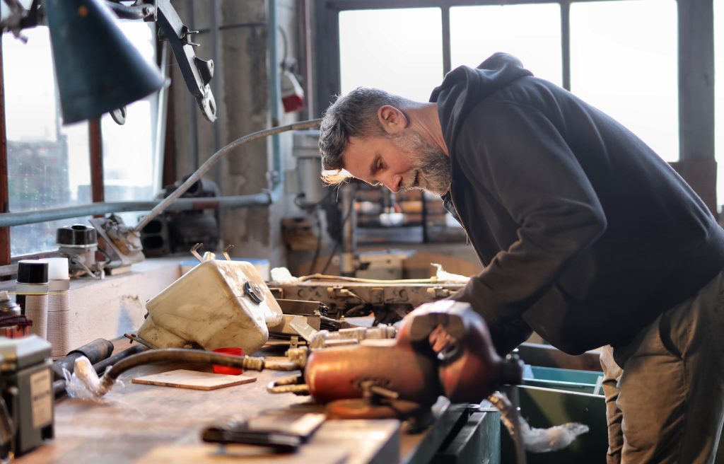 A man is repairing some technical staff