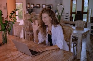 A designer is watching at the screen and waving her hand